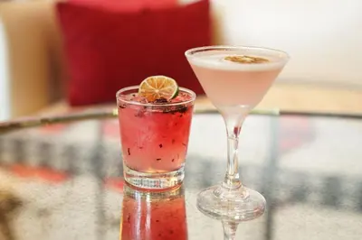 two cocktails sitting on top of a glass table at SpringHill Suites by Marriott Los Angeles Burbank/Downtown in Burbank