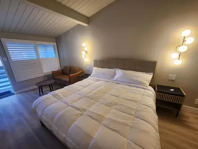 a bedroom with a large bed and a chair at Studio 9 Big Bear Lake in Big Bear Lake