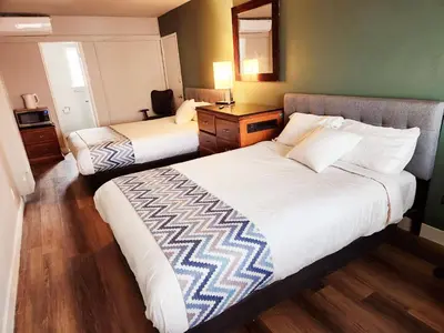 a hotel room with two beds and a mirror at Studio 9 Big Bear Lake in Big Bear Lake
