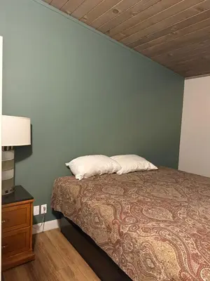 a bedroom with a bed and a blue wall at Studio 9 Big Bear Lake in Big Bear Lake