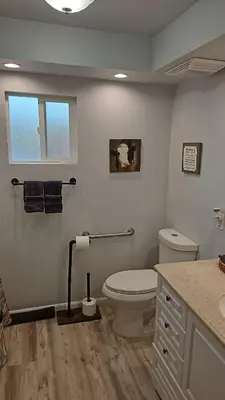 a bathroom with a white toilet and a sink at Alpaca Rustic Ranch-peaceful & breathtaking views in Santa Clarita