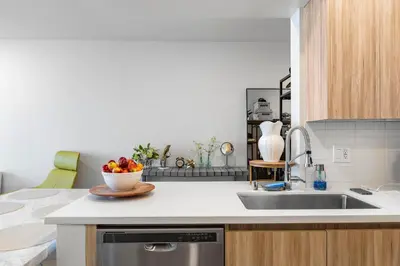 a kitchen with a sink and a bowl of fruit at 8 Santa Monica Huge Stylish Apartment in Los Angeles