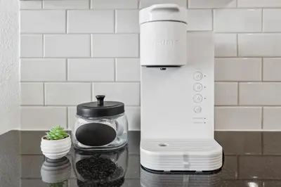 a coffee maker sitting on a counter with a plant in a jar at Marina del Rey getaway,Free parking,Pool,Hot Tub in Los Angeles