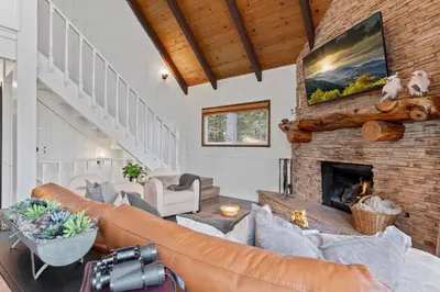 a living room with a couch and a fireplace at Cozy Owl Lodge, Central AC & Hea, Spa Tub & BBQ in Lake Arrowhead