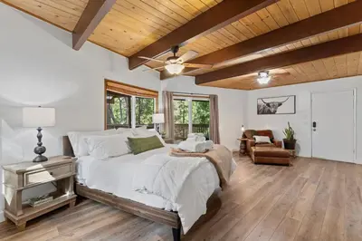 a bedroom with a bed and a wooden ceiling at Cozy Owl Lodge, Central AC & Hea, Spa Tub & BBQ in Lake Arrowhead