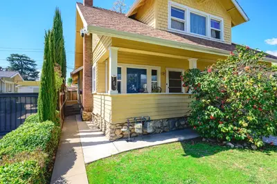 a yellow house with a bush in front of it at Comfortable Home Near LA with Full Kitchen & Laundry in Alhambra