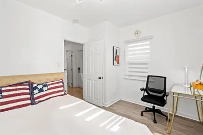 a bedroom with a bed and a desk and a chair at Comfortable Home Near LA with Full Kitchen & Laundry in Alhambra
