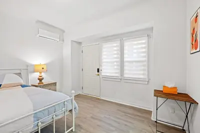 a white bedroom with a bed and a window at Comfortable Home Near LA with Full Kitchen & Laundry in Alhambra