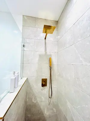 a bathroom with a shower with a shower head at New Lux Skyline Loft in LA in North Sherman Way