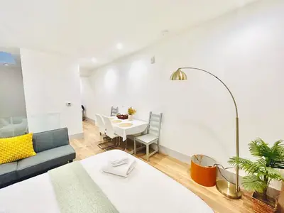 a living room with a table and a couch at New Lux Skyline Loft in LA in North Sherman Way