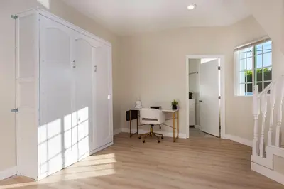 an empty white hallway with a desk and a window at Sunny SoCal Escape 3BR 2BA Bright home with pool in Winnetka