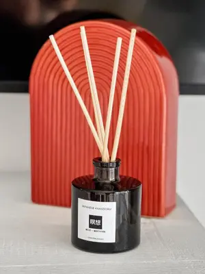 a black jar with bamboo sticks in it on a table at 2BDR Home Away From Home in Marina del Rey in Los Angeles