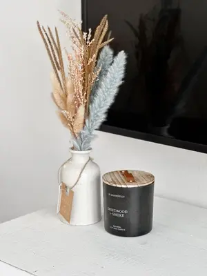 a vase with feathers and a candle on a table at 2BDR Home Away From Home in Marina del Rey in Los Angeles