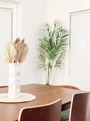 a dining room table with a vase with flowers on it at Charming 4 Bedrooms Family House - WIL-WW in Los Angeles