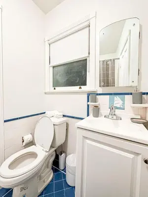 a bathroom with a toilet and a sink and a mirror at Charming 4 Bedrooms Family House - WIL-WW in Los Angeles