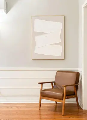 a brown chair sitting in a room with a picture at Elegant 4-Bedroom with Courtyard - WIL- BEV in Los Angeles