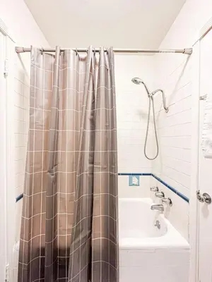 a bathroom with a shower curtain and a sink at Elegant 4-Bedroom with Courtyard - WIL- BEV in Los Angeles