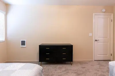 a bedroom with a black dresser and a white door at Relaxing space in Palos Verdes in Rancho Palos Verdes