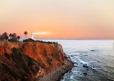 a lighthouse on a cliff with palm trees and the ocean at Relaxing space in Palos Verdes in Rancho Palos Verdes