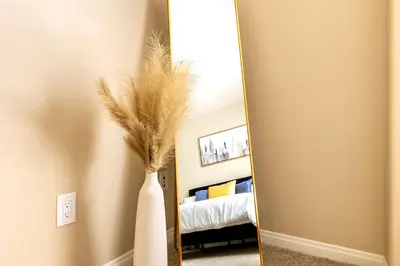 a white vase with feathers in front of a mirror at Marina del Rey 1bdr Retreat with pool, gym, free parking in Los Angeles
