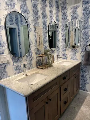 a bathroom with two sinks and two mirrors at Luxe 2-BR with King suite, rooftop, steps from beach in Los Angeles