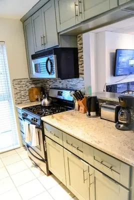 a kitchen with a stove and a counter top at King Oasis - steps to beach with garden patio! in Los Angeles
