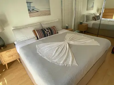 a large white bed in a room with at King Oasis - steps to beach with garden patio! in Los Angeles