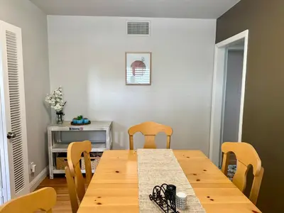 a dining room with a wooden table and chairs at Historic, Family-Friendly Home in Downtown in Bakersfield