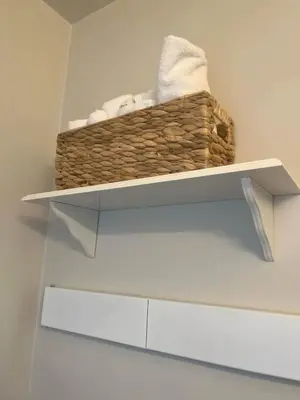 a basket of towels on a shelf in a bathroom at Historic, Family-Friendly Home in Downtown in Bakersfield