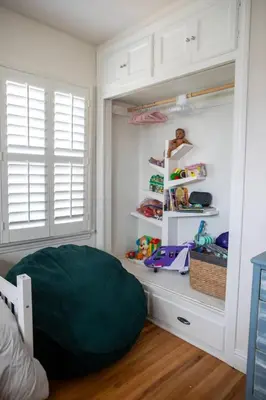 a bedroom with a bed and a shelf with toys at Historic, Family-Friendly Home in Downtown in Bakersfield
