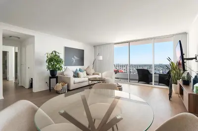 a living room with a table and a couch at The violet-Santa Monica highrise beach front&view in Los Angeles