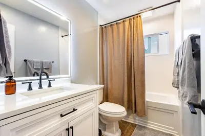 a bathroom with a sink and a toilet at Spacious 4BR Retreat near Disneyland & Beaches in Placentia