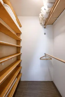 a walk in closet with white walls and wooden shelves at Scenic Retreat with Deck & Stunning Views in LA in Glendale
