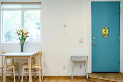 a blue door in a room with a table and chairs at Scenic Retreat with Deck & Stunning Views in LA in Glendale