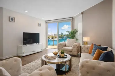a living room with a couch and a tv at Venice Marina Water Front Luxury Condo in Los Angeles