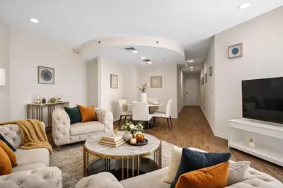 a living room with a couch and a tv at Venice Marina Water Front Luxury Condo in Los Angeles