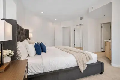 a bedroom with a large bed and a desk at Venice Marina Water Front Luxury Condo in Los Angeles