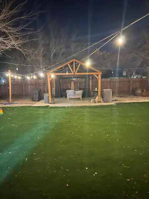 a gazebo with a bench in a yard at night at Luxury Home LA Big Bear & LV 5 Mins to Mall in Victorville