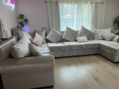 a living room with a large couch with pillows at Luxury Home LA Big Bear & LV 5 Mins to Mall in Victorville