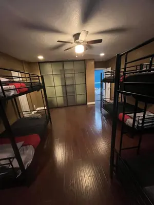 a room with a ceiling fan and bunk beds at Cultura Homes On Crawford in Los Angeles
