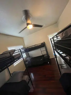 a room with two bunk beds and a ceiling fan at Cultura Homes On Crawford in Los Angeles
