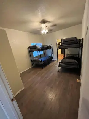 an empty room with two bunk beds in it at Cultura Homes On Crawford in Los Angeles