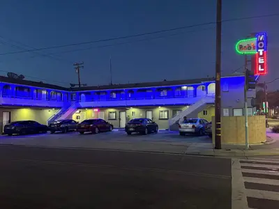 a parking lot with cars parked in front of a building at Bob's Motel in Commerce