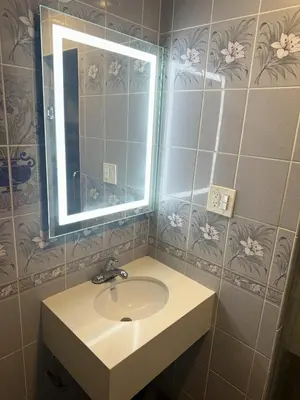 a bathroom with a sink and a mirror at Bob's Motel in Commerce
