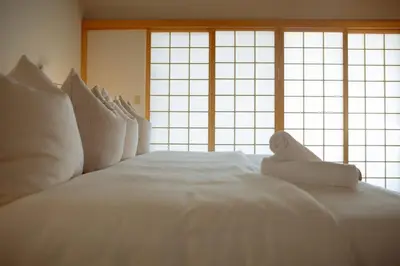 a large white bed with white pillows in front of a window at Villa Mountain Getaway with a Pool Hot Tub 5 Beds in Los Angeles