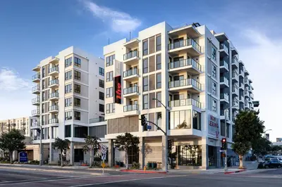 a tall white building on a city street with a traffic light at Blueground San Pedro AC balcony nr USS Iowa LAX-1301 in Los Angeles