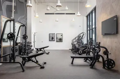a gym with several tread machines and a flat screen tv at Blueground San Pedro AC balcony nr USS Iowa LAX-1301 in Los Angeles