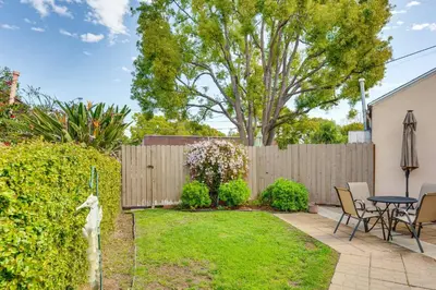 a backyard with a fence and a table and chairs at 2 Mi to Griffith Park Chic Home with Private Patio in Burbank