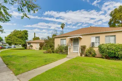a house with a green lawn in front of it at 2 Mi to Griffith Park Chic Home with Private Patio in Burbank