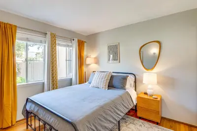 a bedroom with a bed and a mirror on the wall at 2 Mi to Griffith Park Chic Home with Private Patio in Burbank